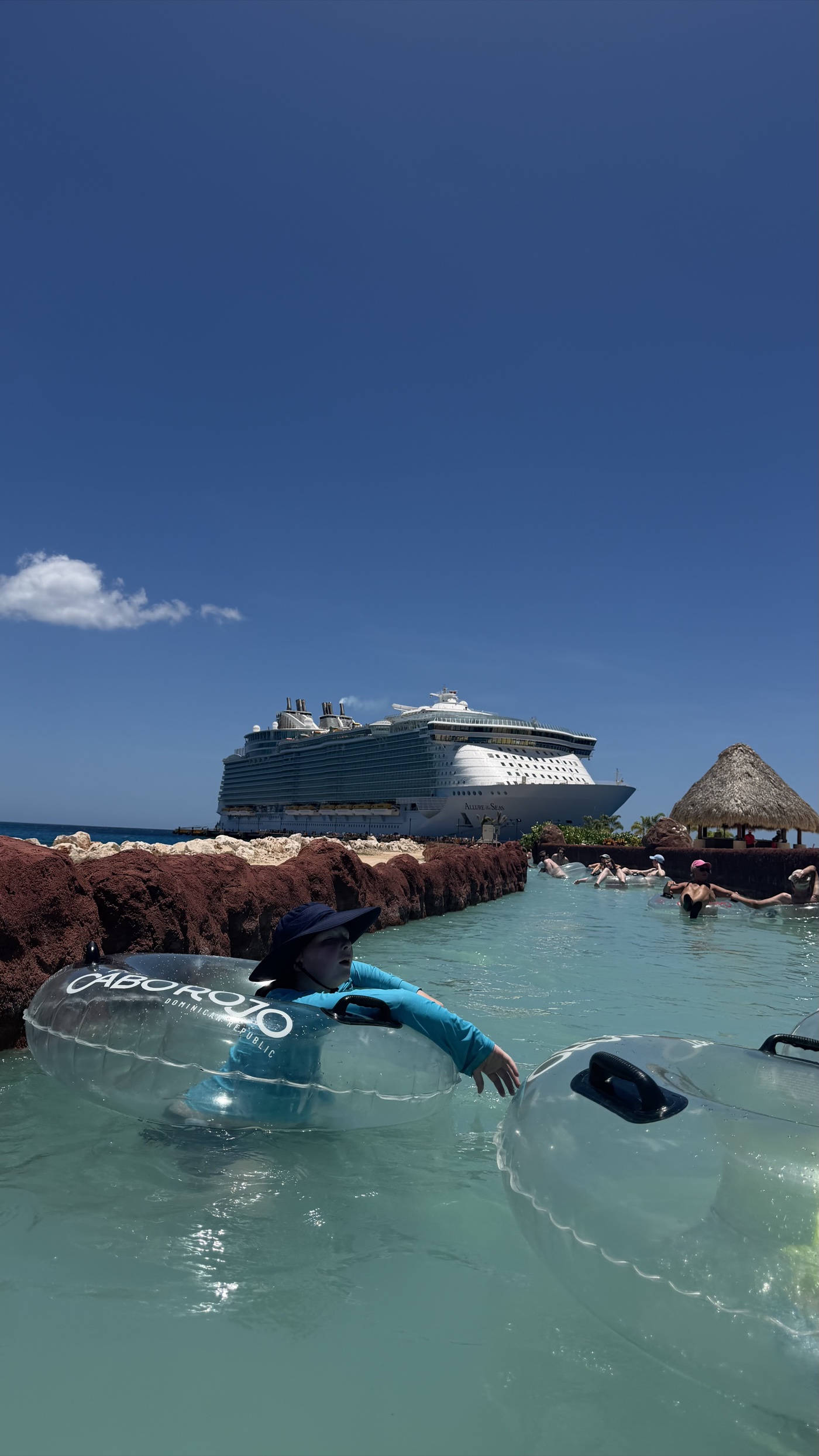 Floating a lazy river in a Cabo Rojo tube with Allure of the Seas docked behind