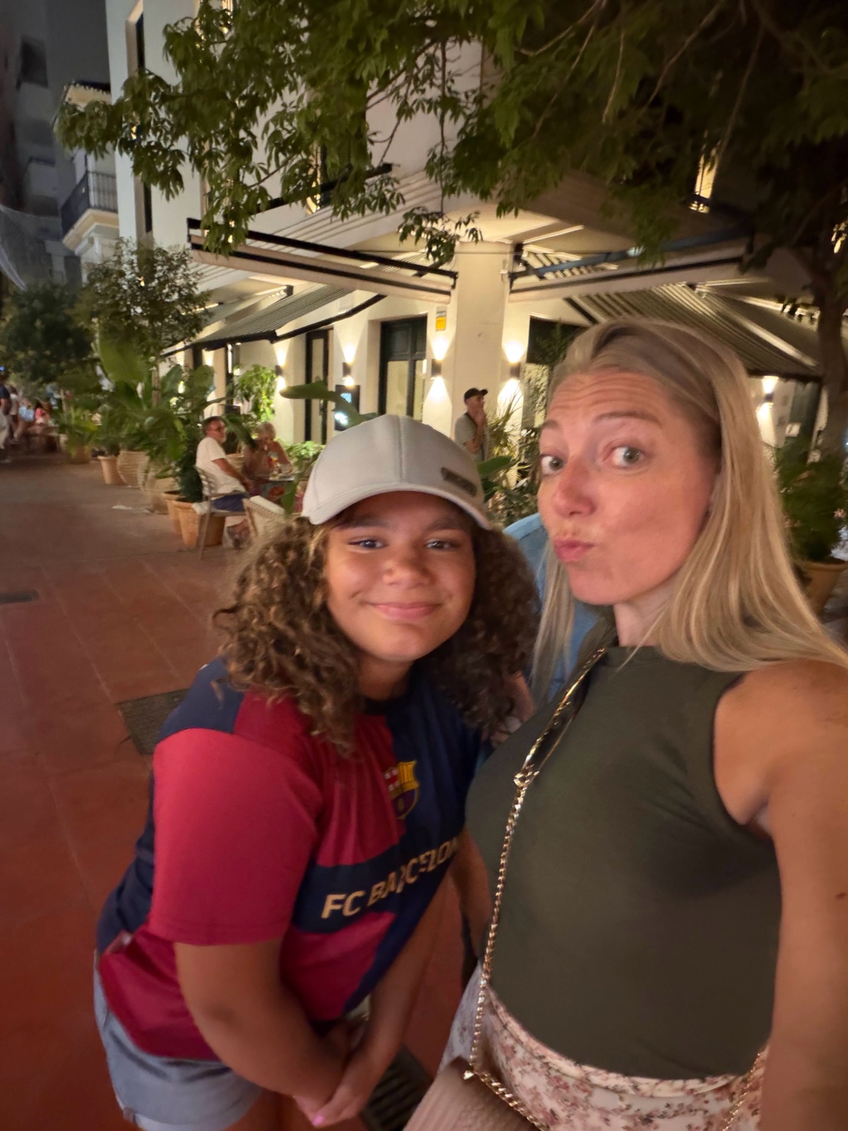 Ashley and Abby out in the plaza on the night of the final, Abby wearing an FC Barcelona shirt