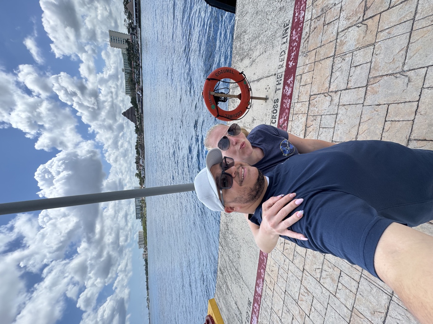 Ashley and Miguel at the ship's railing in sunglasses, messing around before getting off in port