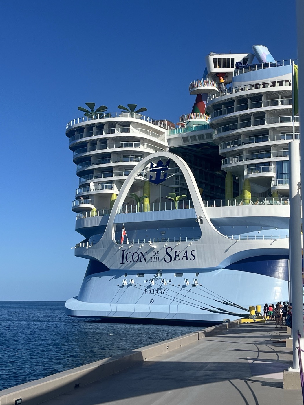 Icon of the Seas at port in Nassau, the iconic ship arch with the Royal Caribbean logo center frame