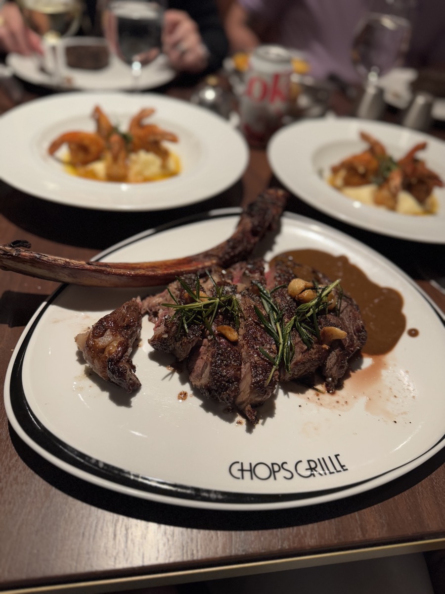 Tomahawk steak plated at Chops Grille on Icon of the Seas