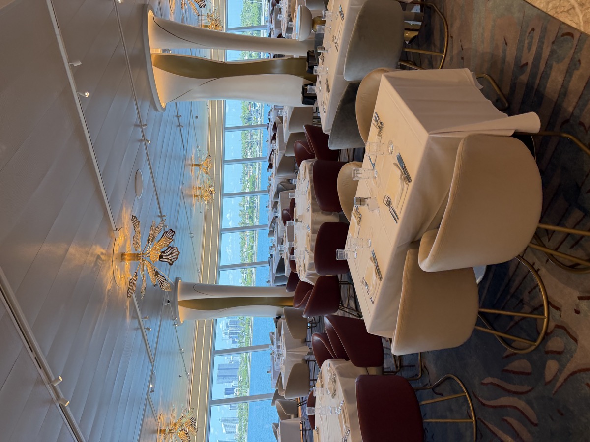 Main dining room on Norwegian Luna with chandeliers and floor-to-ceiling windows