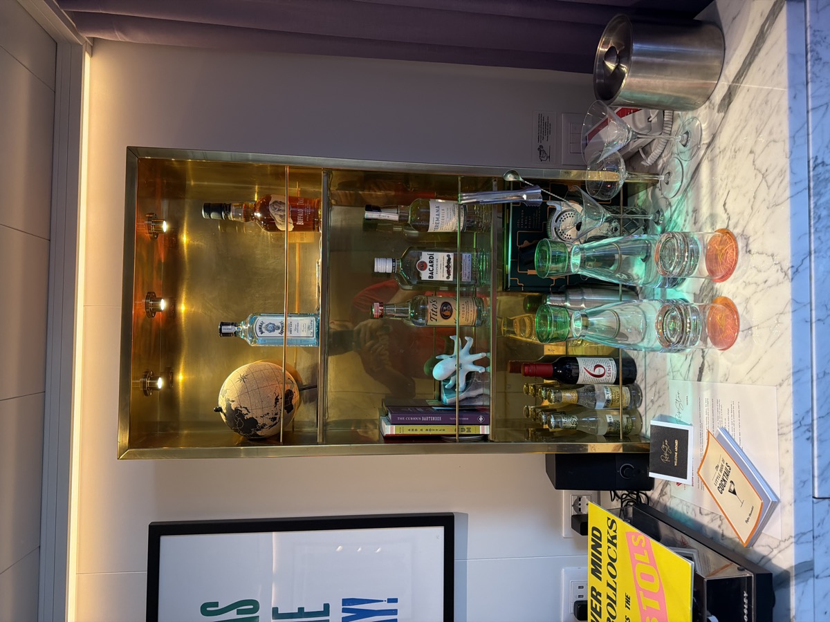 In-suite bar setup with curated spirits and glassware on a marble surface