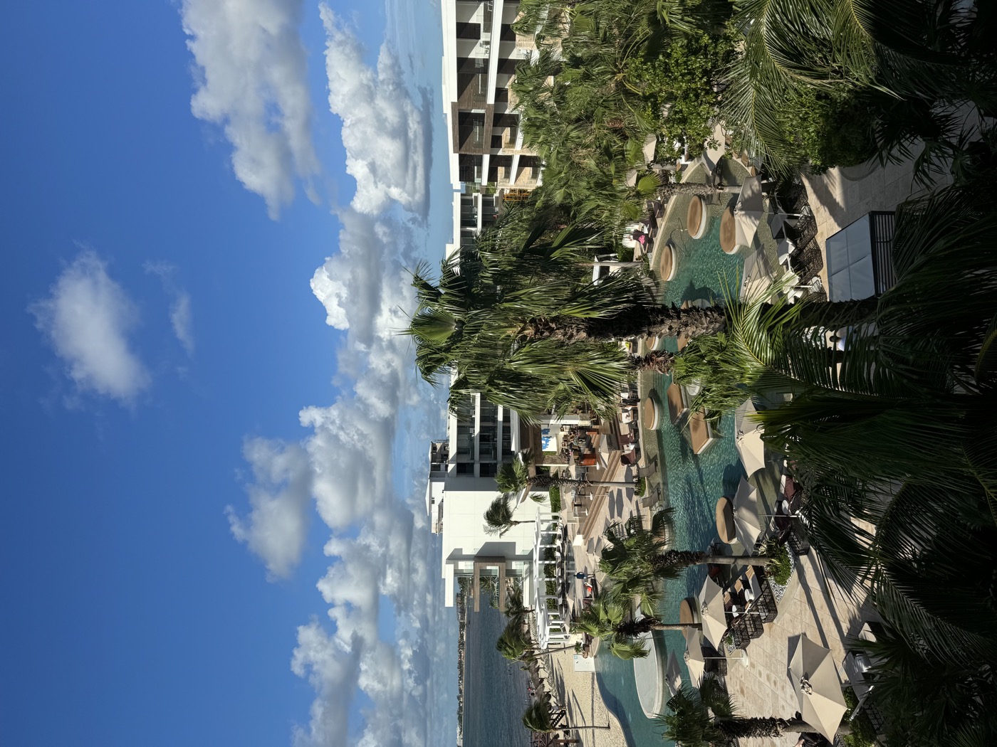 Resort pool layout at Secrets Riviera Cancun, multi-pool with palms and palapas
