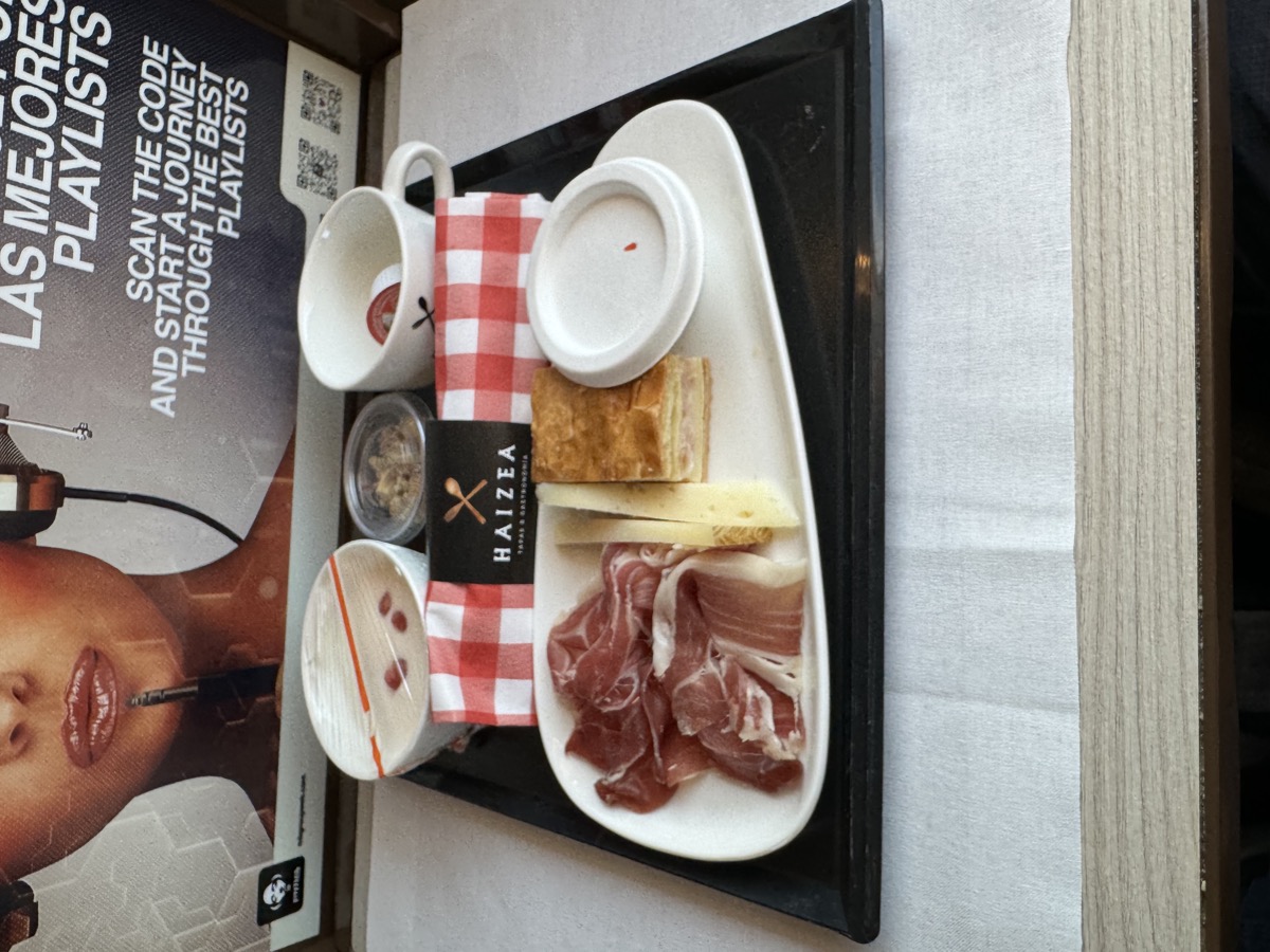 First-class Iryo bullet train tapas service tray — jamón, cheese, croquettes