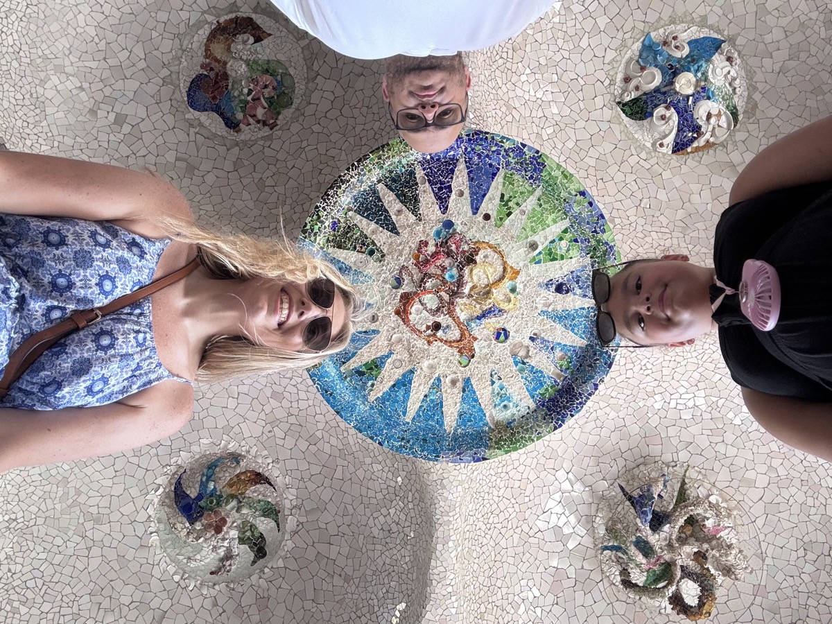Looking up at the mosaic ceiling at Park Güell with family selfie