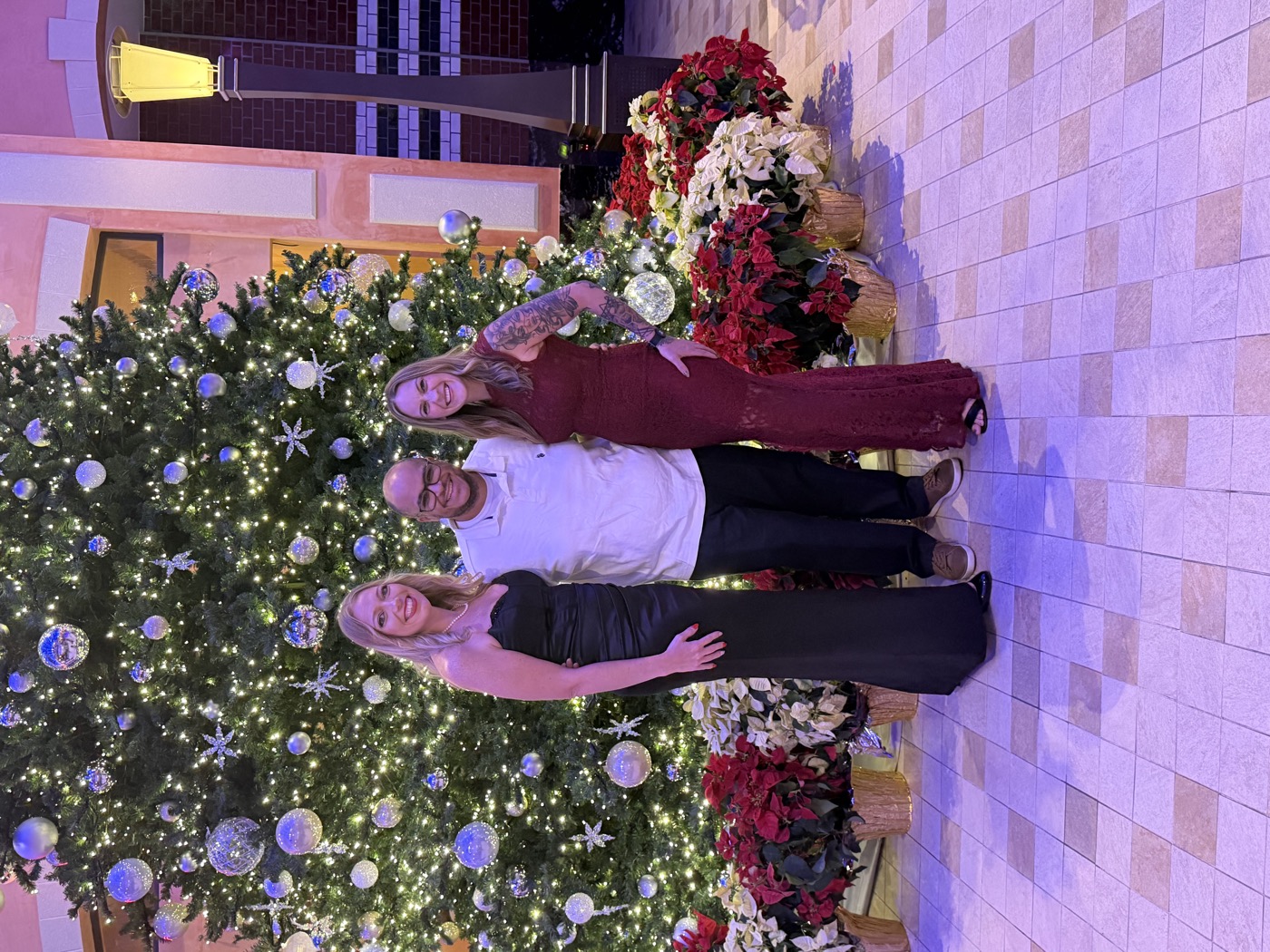 Family in front of the giant Christmas tree on the Royal Promenade